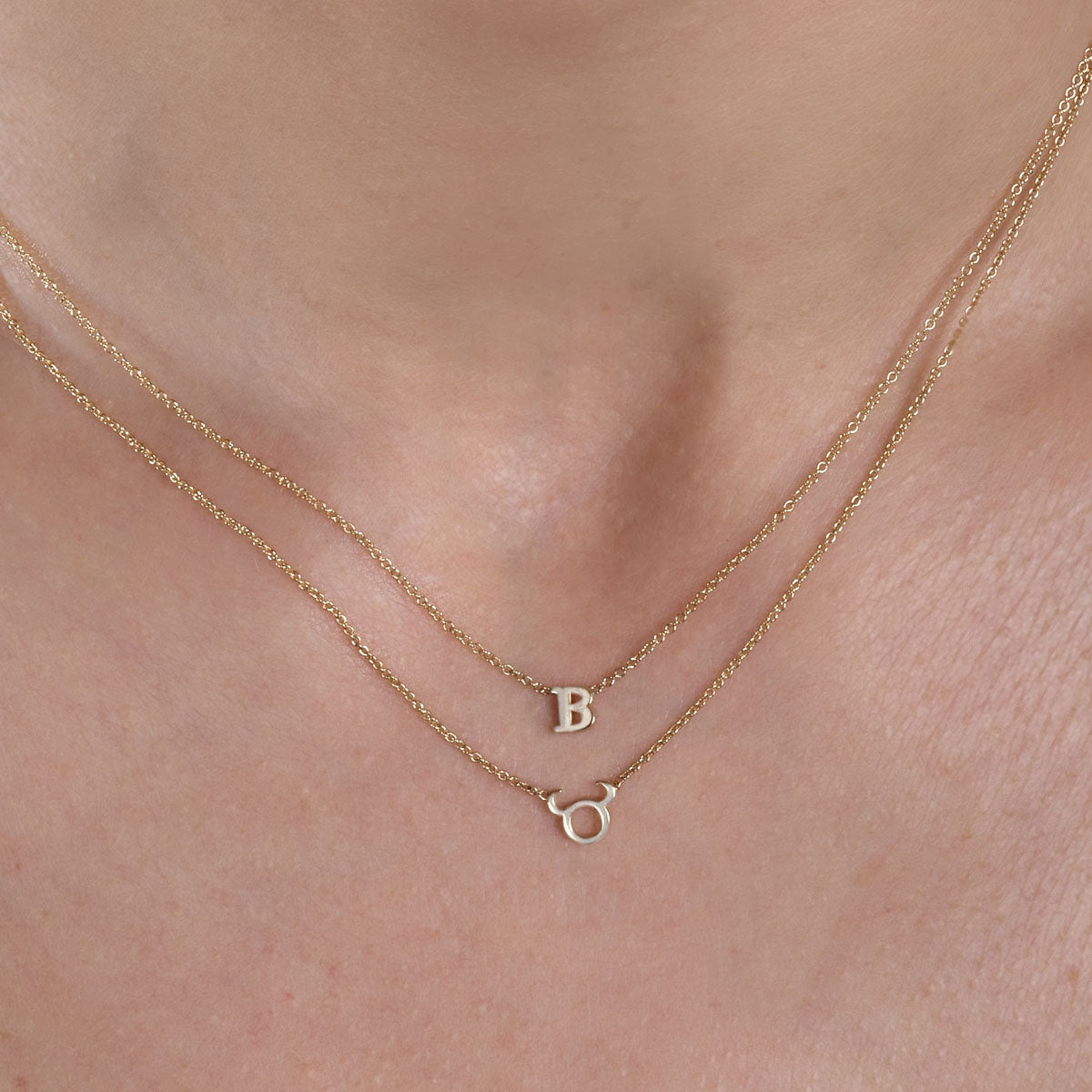 Gold initial necklace and Taurus zodiac pendant - layered personalized jewelry