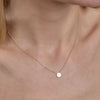 Gold diamond round pendant - elegant circle necklace on woman's neck